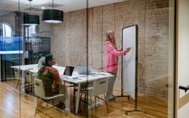 Jolinda writing on a whiteboard