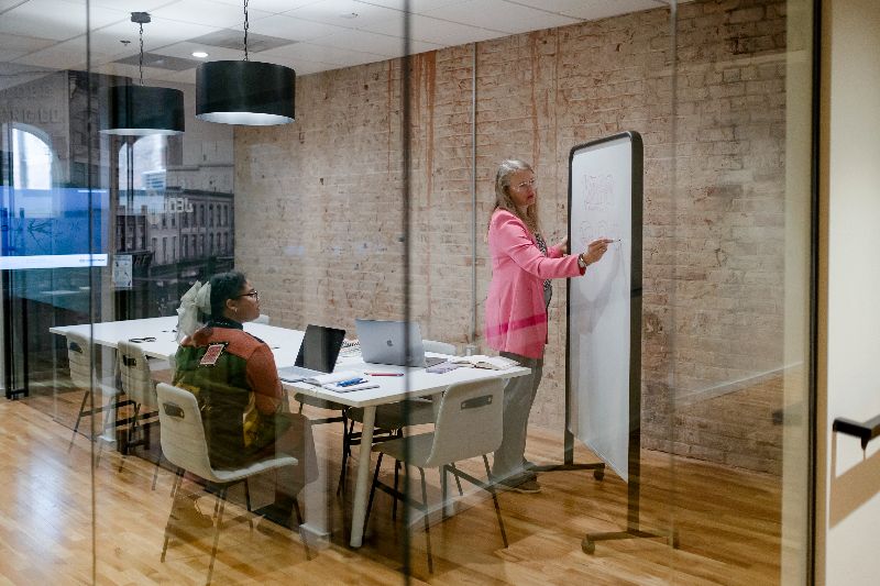 Jolinda writing on a whiteboard