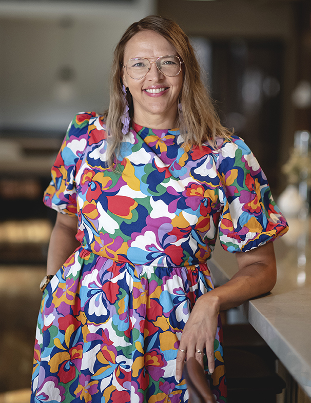 Jolinda Anderson, web designer and owner of Shapes & Colors by Jolinda, standing at a counter inside her downtown Richmond, Virginia workspace