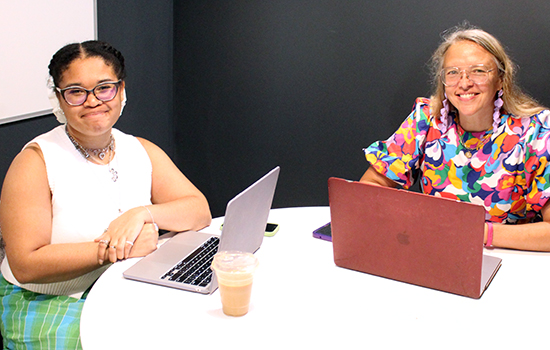 Cierra Fountain an Jolinda Anderson working on designs on their laptops in a Gather Arts District office in downtown Richmond, VA